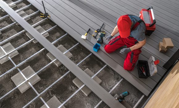Composite Patio Floor Installation Made by Professional Construction Worker. Backyard Patios Theme,