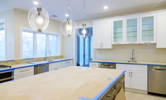 White of kitchen wooden cabinets with contemporary look of installation base for island in center